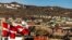 FILE - The Greenlandic and Danish, left, flags flutter in Ilulissat, western Greenland, June 29, 2022.