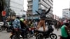 A person stands on a motorbike as pro-government protesters parade to counter an anti-government demonstration, following nationwide deadly riots over tax hikes, in Nairobi, Kenya, July 23, 2024. 