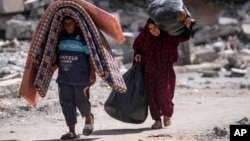 Palestinians displaced by an Israeli air and ground offensive in the Gaza Strip flee from Hamad City following an evacuation order by the Israeli army to leave parts of the southern area of Khan Younis, Aug. 11, 2024.