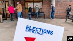 Los votantes hacen fila cuando se abren las puertas del Centro Electoral para la votación anticipada en ausencia para las elecciones generales en Sterling Heights, Michigan, el 29 de octubre de 2020.