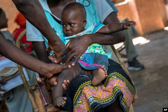 FILE - A baby from Malawi is injected with the world's first vaccine against malaria on Dec. 11, 2019. The WHO approved a second malaria vaccine that could offer a cheaper and more effective shot against the parasitic disease. (AP Photo/Jerome Delay, File)