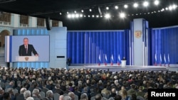 Russian President Vladimir Putin delivers his annual address to the Federal Assembly in Moscow, Russia, Feb. 21, 2023. (Sputnik/Ramil Sitdikov/Kremlin via Reuters)