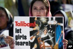 An Afghan refugee woman rallies to mark International Women's Day, in Islamabad, Pakistan, March 8, 2023. The day, officially recognized by the United Nations in 1977, is celebrated around the world on March 8.