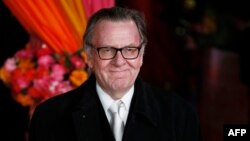 FILE — English actor Tom Wilkinson poses for photographers on the red carpet ahead of the Royal and World Premiere of the film "The Second Best Exotic Marigold Hotel" in London, Feb. 17, 2015. Wilkinson died suddenly on Saturday.