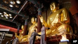 Buddhists monks clean Buddha statues ahead of the upcoming birthday of Buddha on May 15, at the Jogye temple in Seoul, South Korea, Tuesday, May 7, 2024. (AP Photo/Ahn Young-joon)