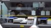 FILE - A forensic scientist watches a machine analyze samples in the DNA lab during a tour of the Orange County, California Crime Lab in Santa Ana, California August 14, 2013. 
