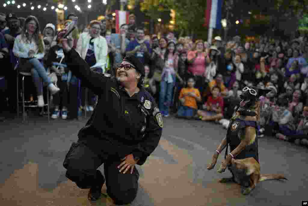 Police dog instructor Adriana Ayala takes a selfie with her dog during an exhibition to celebrate the 212th Anniversary of Paraguay&acute;s Independence from Spain, in Asunción, Paraguay, May 14, 2023.