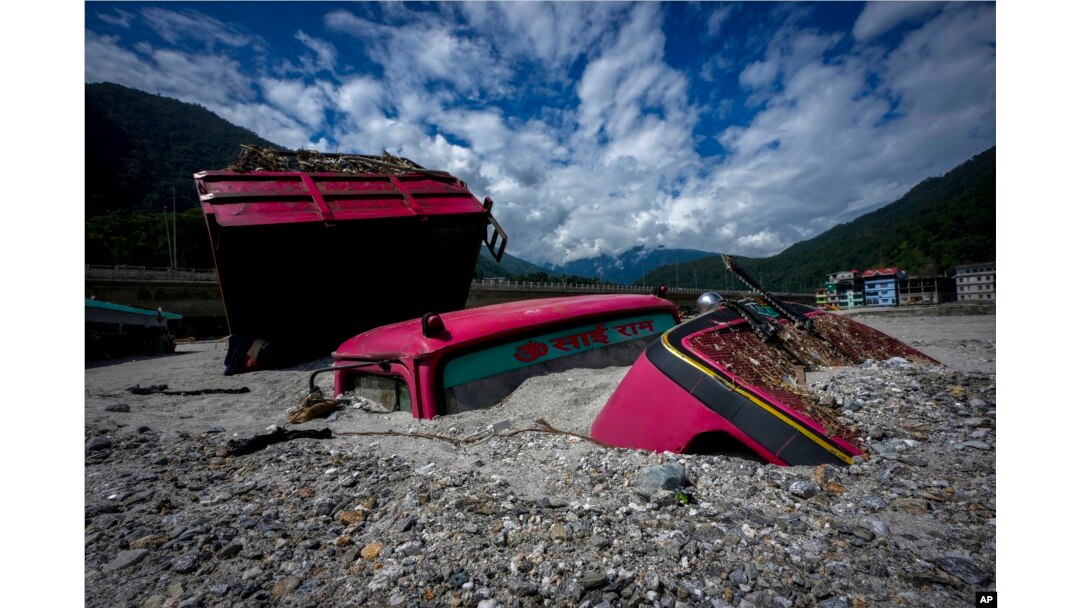 Vehicles lie submerged in mud in the flood affected area along the Teesta river in Rongpo, east Sikkim, India, Oct. 8. 2023.