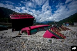 Vehicles lie submerged in mud in the flood affected area along the Teesta river in Rongpo, east Sikkim, India, Oct. 8. 2023.