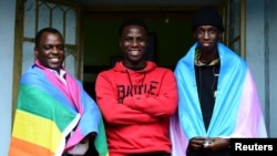 FILE - Ugandan LGBTQ activist Frank Mugisha poses for a photograph with LGBTQ members Eric Ndawula and Bana Mwesige after a Reuters interview in Makindye suburb, of Kampala, Uganda on March 30, 2023.