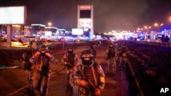 Russian Rosguardia (National Guard) servicemen secure an area at the Crocus City Hall on the western edge of Moscow, Russia, March 23, 2024. Several gunmen have burst into a big concert hall in Moscow and fired automatic weapons at the crowd.