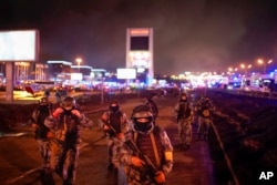 Russian Rosguardia (National Guard) servicemen secure an area at the Crocus City Hall on the western edge of Moscow, March 23, 2024.