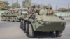 FILE - Zambian Army armored personnel carriers patrol the Chawama Compound in Lusaka on Aug. 3, 2021. Officials in Zimbabwe have alleged the United States is plotting to move its Africa Command to neighboring Zambia from Germany, an accusation the U.S. and Zambia deny.