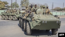 FILE - Zambian Army armored personnel carriers patrol the Chawama Compound in Lusaka on Aug. 3, 2021. Officials in Zimbabwe have alleged the United States is plotting to move its Africa Command to neighboring Zambia from Germany, an accusation the U.S. and Zambia deny.