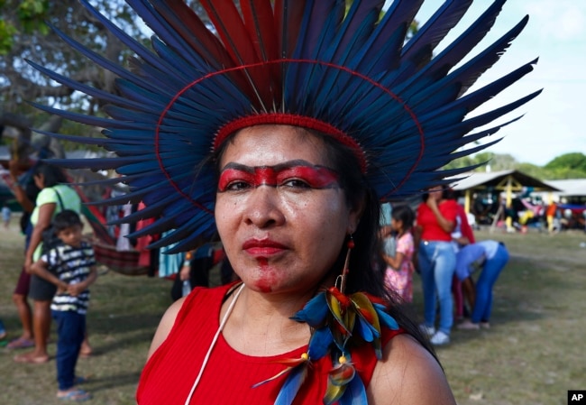 Tawrepang Indigenous woman Leticia Monteiro da Silva poses for photos at the Caracarana Lake Regional Center in Normandia, on the Raposa Serra do Sol Indigenous reserve in Roraima state, Brazil, Monday, March 13, 2023. (AP Photo/Edmar Barros)