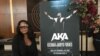 A fan poses for a photograph at the memorial of South Africa rapper Kiernan Forbes, known as AKA on Feb. 17 at the Sandton Convention Center in Johannesburg, South Africa. (VOA/Thuso Khumalo) 