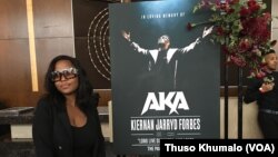 A fan poses for a photograph at the memorial of South Africa rapper Kiernan Forbes, known as AKA on Feb. 17 at the Sandton Convention Center in Johannesburg, South Africa. (VOA/Thuso Khumalo) 