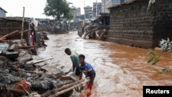 Residents sift through the rubble as they recover their belongings after the Nairobi river burst its banks and destroyed their homes within the Mathare Valley settlement in Nairobi, Kenya, April 25, 2024.