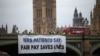 Anggota kelompok kampanye "Just Treatment (Perlakuan Adil)" memasang spanduk dari Westminster Bridge di pusat kota London untuk mendukung aksi mogok yang dilakukan oleh dokter junior, 27 Juni 2024, seminggu sebelum pemilihan umum 4 Juli. (HENRY NICHOLLS / AFP)
