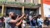 FILE - Journalists outside Harare Magistrate Courts (April 2023) where a number of activists have been arraigned before to answer different charges. (Columbus Mavhunga/VOA)
