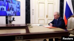 Russian President Vladimir Putin chairs a meeting with members of the Security Council via a video link in Moscow, Russia May 26, 2023.