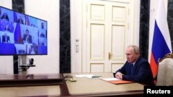 Russian President Vladimir Putin chairs a meeting with members of the Security Council via a video link in Moscow, Russia May 26, 2023.