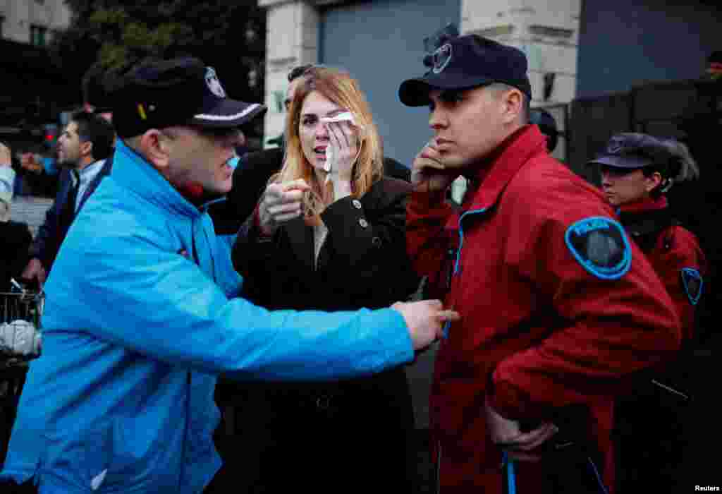 Lilia Lemoine, a candidate for Argentina&#39;s lower house of Congress, with the Libertad Avanza coalition, covers her eye after an alleged attack by protesters, outside the Buenos Aires City Legislature, in Buenos Aires, Sept. 4, 2023. Protesters were demonstrating against an event organized by Victoria Villarruel, running mate of presidential candidate Javier Milei of La Libertad Avanza coalition, to honor the victims of armed leftist groups during the 1970s.