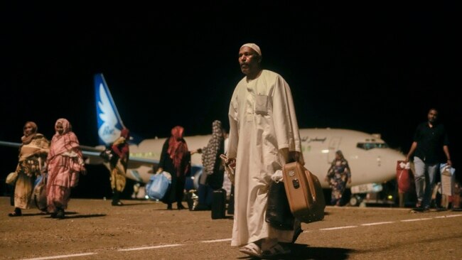 Sudanese, who had been stranded in Jeddah, Saudi Arabia, arrive at Port Sudan airport, Thursday, May 11, 2023.