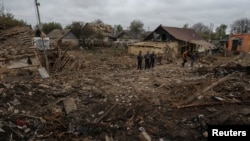 Police are seen at the site of a residential area hit by a Russian military strike in the town of Pavlohrad, in Ukraine's Dnipropetrovsk region, May 1, 2023.