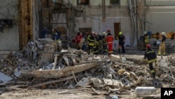 Rescue workers clear the rubble at the site of Okhmatdyt children's hospital hit by Russian missiles a day earlier, in Kyiv, Ukraine, July 9, 2024.