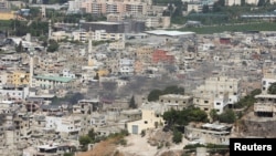 Smoke rises from Ain el-Hilweh Palestinian refugee camp during Palestinian faction clashes, in Sidon, Lebanon, Sept. 11, 2023.