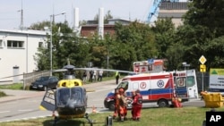 FILE - Rescuers transport an injured miner to an air ambulance near the Rydultowy coal mine near the city of Rybnik, in southern Poland, July 11, 2024. Officials say that a miner who was missing after an earthquake shook the mine has been found alive.