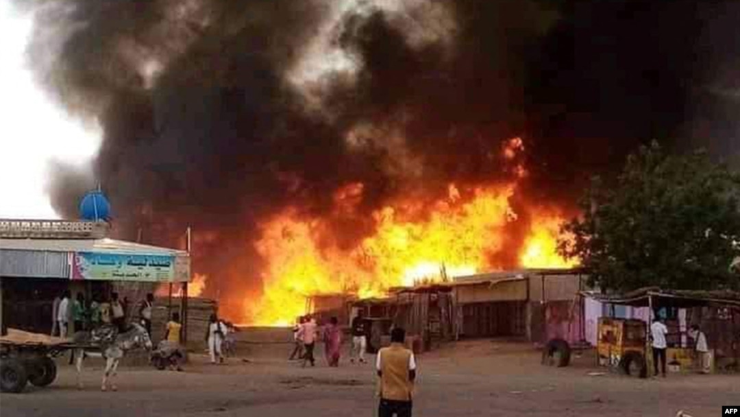 FILE—A man stands by as a fire rages in a livestock market area in al-Fasher, the capital of Sudan's North Darfur state, on September 1, 2023, in the aftermath of bombardment by the paramilitary Rapid Support Forces (RSF). 