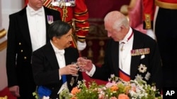 Britain's King Charles III, right, and Japan's Emperor Naruhito toast glasses at the State Banquet in London, during the State Visit of the Japanese Emperor and Empress to Britain, June 25, 2024.