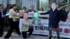 South Korean protesters wearing masks with the faces of Japanese Prime Minister Fumio Kishida, right, and South Korean President Yoon Suk Yeol are seen during a rally prompted by a dispute with Japan over the social media app Line, in Seoul, May 14, 2024. 