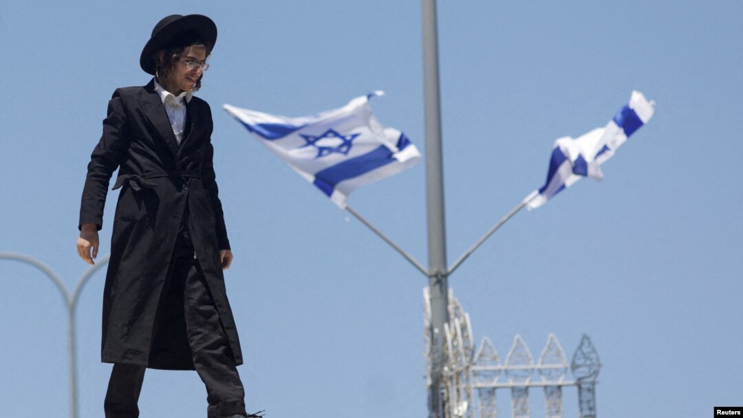 FILE- An ultra-Orthodox Jewish man reacts during a demonstration after the Supreme Court ruled the defense ministry could no longer grant blanket military conscription exemptions to Jewish seminary students, at Tel HaShomer recruitment base in Ramat Gan, Israel, Aug. 5, 2024. 
