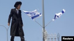 FILE- An ultra-Orthodox Jewish man reacts during a demonstration after the Supreme Court ruled the defense ministry could no longer grant blanket military conscription exemptions to Jewish seminary students, at Tel HaShomer recruitment base in Ramat Gan, Israel, Aug. 5, 2024. 