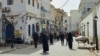 (FILE) People walk in the Old City of Tripoli, Apr. 27, 2024. 