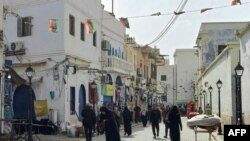 FILE - People walk in the Old City of Tripoli, Apr. 27, 2024. The UN high commissioner for human rights presented Tuesday a stinging rebuke of the methods employed by Libya’s governing elite to eviscerate its political opponents and remain in charge.