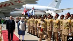 Egypt's Prime Minister Mostafa Madbouly left, and his Indian counterpart Narendra Modi walk during a welcome ceremony in Cairo, Egypt, June 24, 2023.