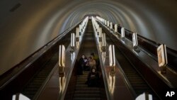 People take a shelter in a subway station being used as a bomb shelter during an air siren in Kyiv, Ukraine.
