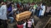 Relatives mourn as the coffin of Florence Masika, who was killed along with her son Zakayo Masereka by suspected rebels as they retreated from Saturday's attack on the Lhubiriha Secondary School, is buried in Nyabugando, Uganda, June 18, 2023. 