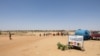 FILE - People cross the border between Sudan and Chad at a post in Adre on April 11, 2024. Officials say an influx of refugees, armed conflicts, climate change, floods, droughts and agricultural disasters have led to unprecedented food insecurity in Chad.