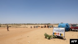 FILE - People cross the border between Sudan and Chad at a post in Adre on April 11, 2024. Officials say an influx of refugees, armed conflicts, climate change, floods, droughts and agricultural disasters have led to unprecedented food insecurity in Chad.