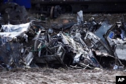 The wreckage of the trains lie next to the rail lines, after Tuesday's rail crash, the country's deadliest on record, in Tempe, about 376 kilometers north of Athens, near Larissa city, Greece, March 3, 2023.