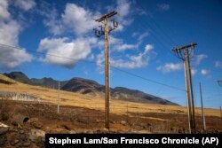 Utility poles stand in Lahaina on the island of Maui, Hawaii, Aug. 16, 2023. (Stephen Lam/San Francisco Chronicle via AP)