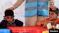 FILE - Children attend an activity to entertain and support the mental health of children affected by the deadly earthquake, at a camp for survivors in Adiyaman, Turkey, February 18, 2023. (REUTERS/Thaier Al-Sudani/File Photo)