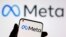 FILE - A smartphone with Meta logo is seen in front of displayed Facebook's new rebrand logo Meta in this illustration taken Oct. 28, 2021. 