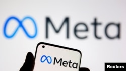 FILE - A smartphone with Meta logo is seen in front of displayed Facebook's new rebrand logo Meta in this illustration taken Oct. 28, 2021. 