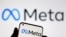 FILE - A smartphone with Meta logo is seen in front of displayed Facebook's new rebrand logo Meta in this illustration taken Oct. 28, 2021. 